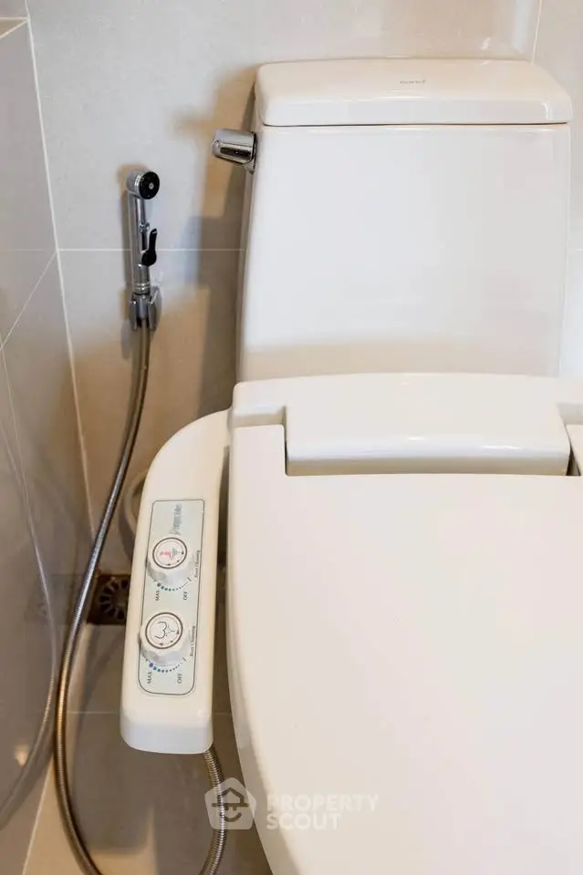 Modern bathroom with advanced bidet toilet and sleek design.
