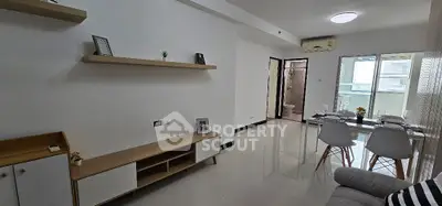 Modern living room with dining area and balcony access in stylish apartment