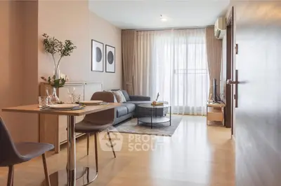 Modern living room with elegant decor and natural light, featuring a cozy seating area and stylish dining setup.