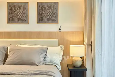 Elegant bedroom with cozy lighting and stylish decor, featuring a comfortable bed and modern wall art.