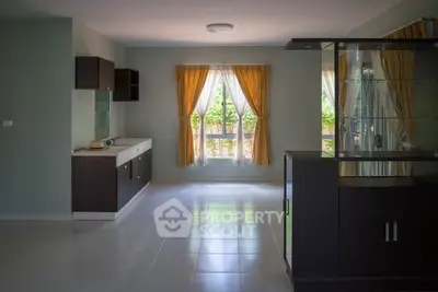 Spacious living room with modern cabinetry and large windows for natural light.