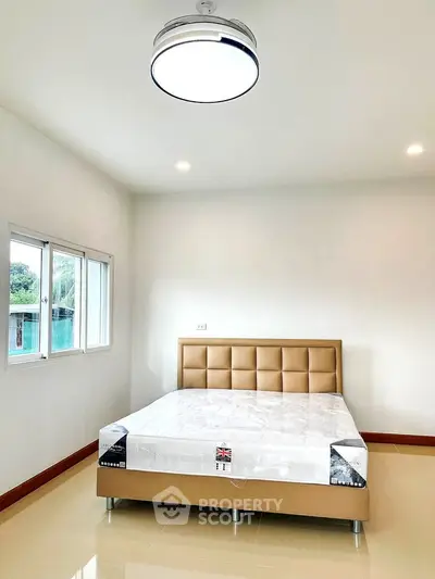 Spacious bedroom with modern bed and natural light