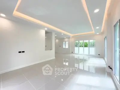 Spacious modern living room with sleek tile flooring and recessed lighting