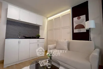 Modern studio apartment with sleek kitchenette and cozy living area, perfect for urban living.