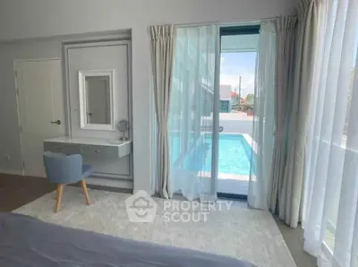 Elegant bedroom with pool view and stylish decor