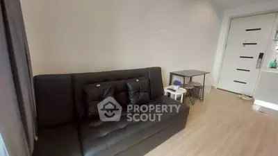 Modern living room with sleek black sofa and minimalist decor