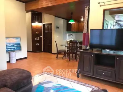 Spacious living room with open kitchen, elegant decor, and modern furnishings for a cozy home ambiance.