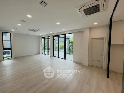 Spacious modern living room with large windows and garden view