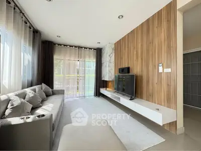 Modern living room with sleek design, large windows, and stylish wood paneling.