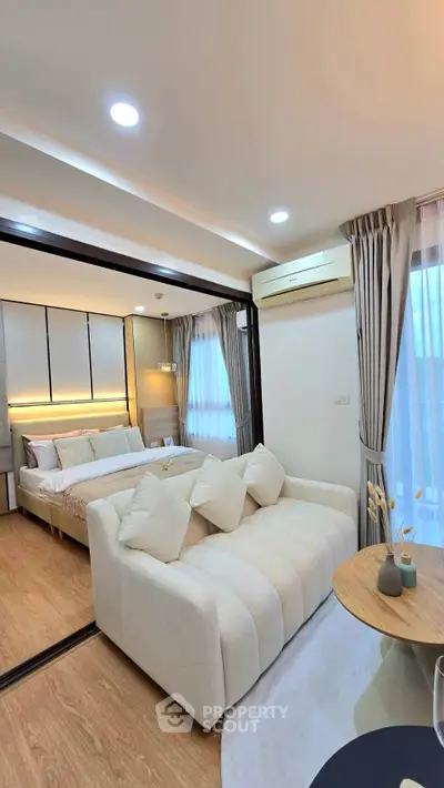 Modern studio apartment with cozy living area and stylish bedroom