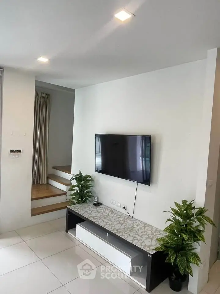 Modern living room with wall-mounted TV and stylish decor