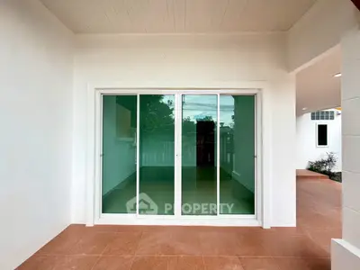 Modern patio with sliding glass doors and tiled flooring