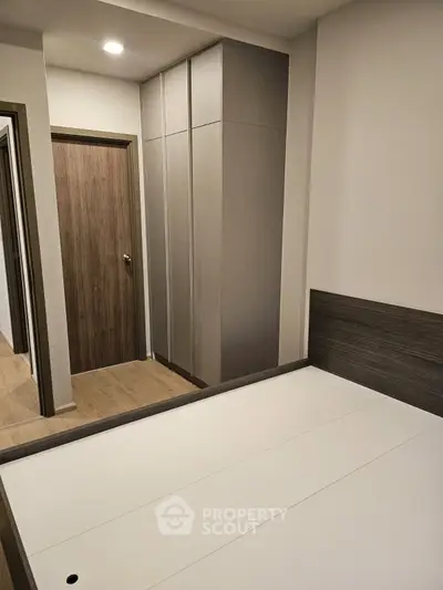 Modern bedroom with sleek wardrobe and minimalist design
