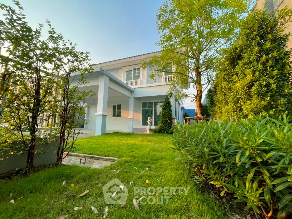 Charming two-story house with lush garden and spacious balcony, perfect for family living.