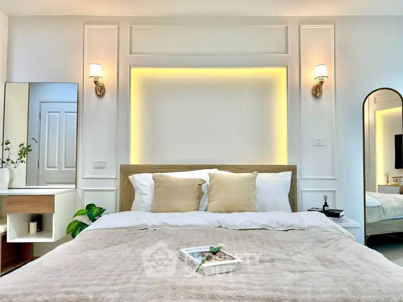 Luxurious bedroom with elegant lighting and cozy decor, perfect for relaxation and comfort.