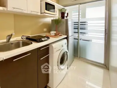 Modern kitchen with washing machine and sleek appliances in compact layout