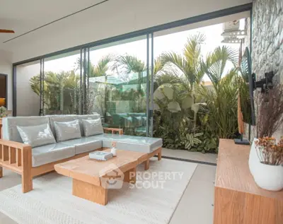 Luxurious living room with modern furniture and lush garden view