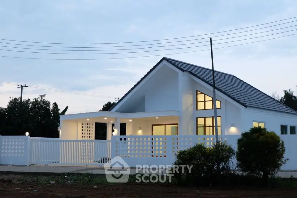Modern white house with sleek design and spacious yard, perfect for contemporary living.