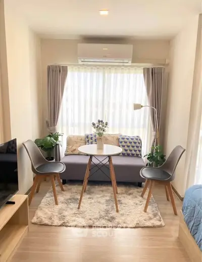 Charming living room with cozy seating and natural light, perfect for relaxation.