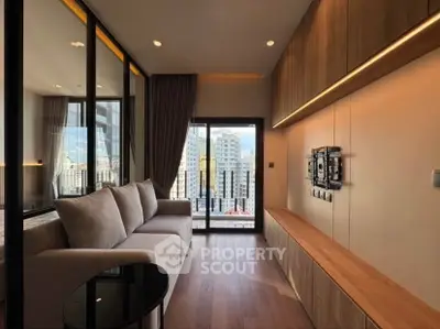 Modern living room with large windows and city view, featuring sleek furniture and warm lighting.