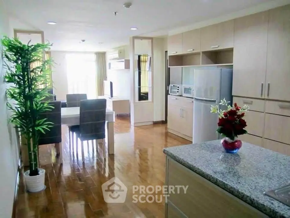 Spacious open-plan kitchen and dining area with modern appliances and elegant decor.