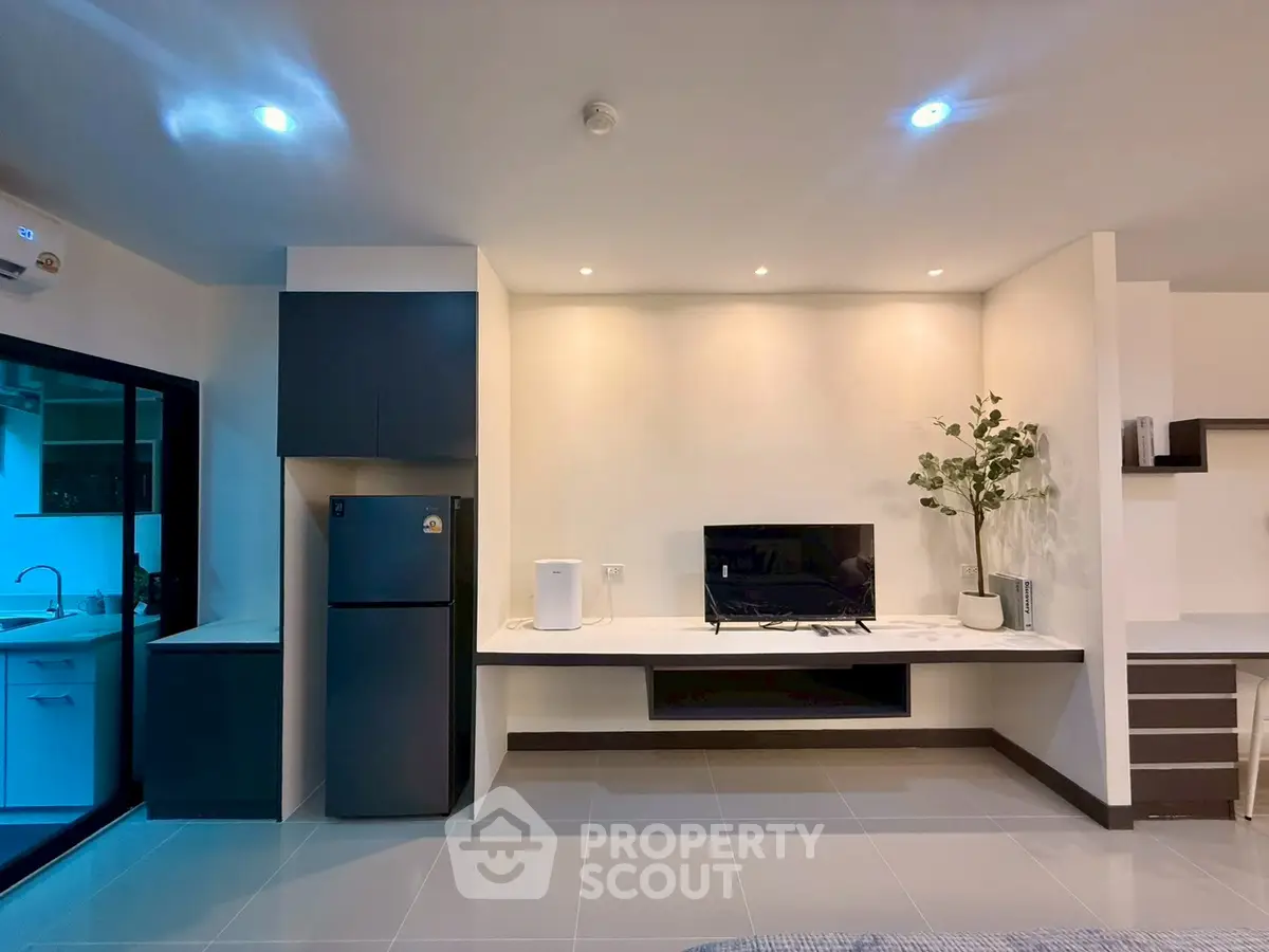 Modern living room with sleek design and integrated kitchen view