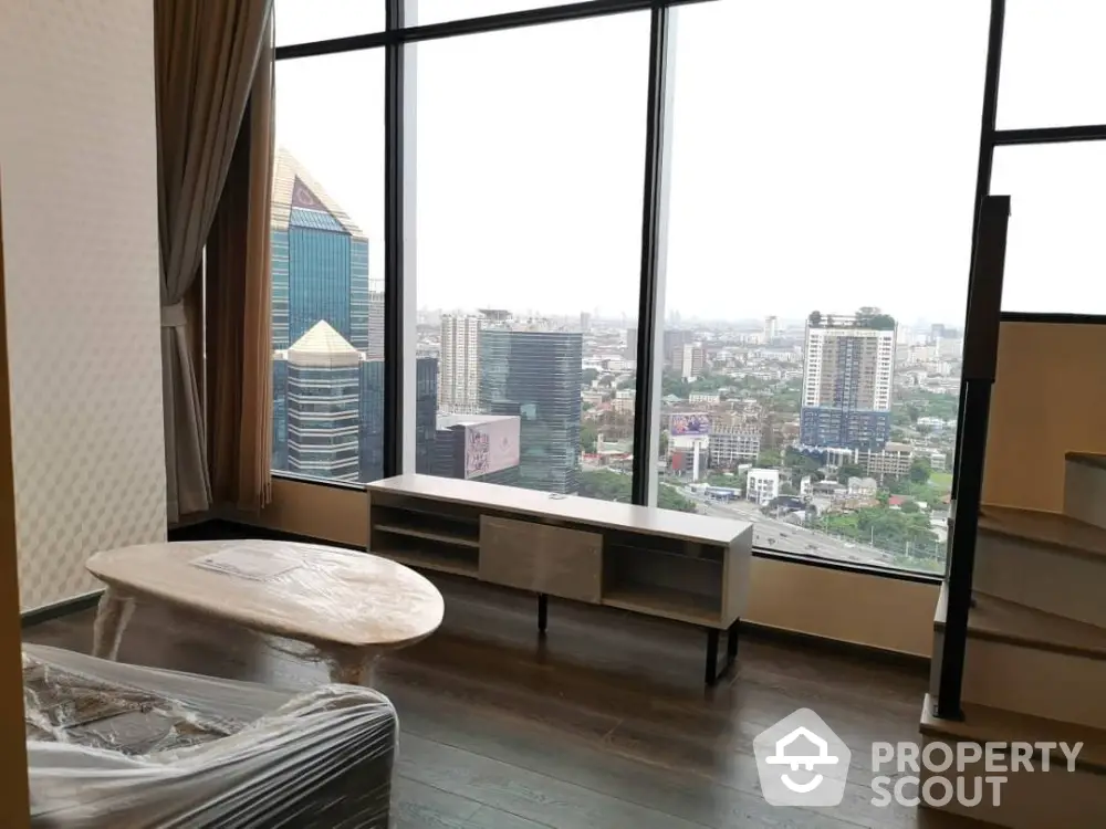 Stunning high-rise living room with panoramic city view and modern furnishings.