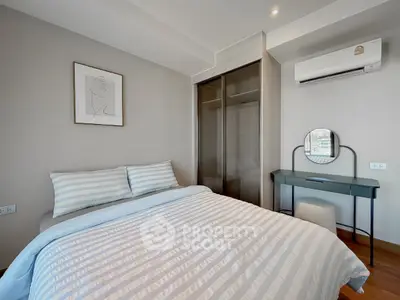 Modern bedroom with stylish decor and air conditioning in a cozy apartment.