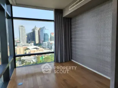 Spacious corner unit with floor-to-ceiling windows offering a stunning city view, perfect for urban living.