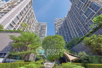 Stunning modern apartment complex with lush greenery and towering architecture.