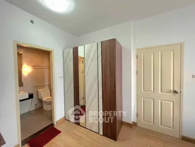 Modern bedroom with ensuite bathroom and stylish wardrobe in a cozy apartment.