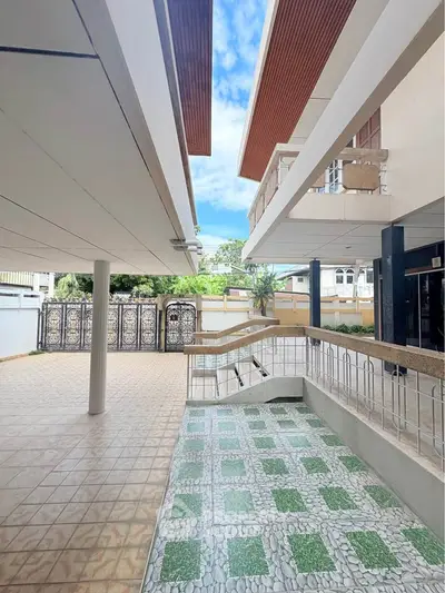 Spacious modern building entrance with tiled flooring and elegant design.