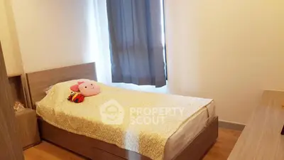 Cozy bedroom with single bed and wooden furniture, perfect for a peaceful retreat.