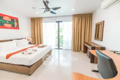 Spacious bedroom with modern decor and balcony access in luxury apartment.