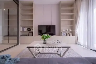 Modern living room with sleek TV setup and elegant shelving, perfect for stylish urban living.