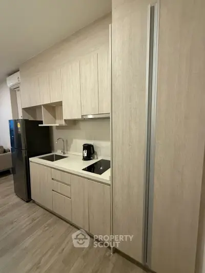 Modern kitchen with sleek cabinetry and built-in appliances in a stylish apartment.