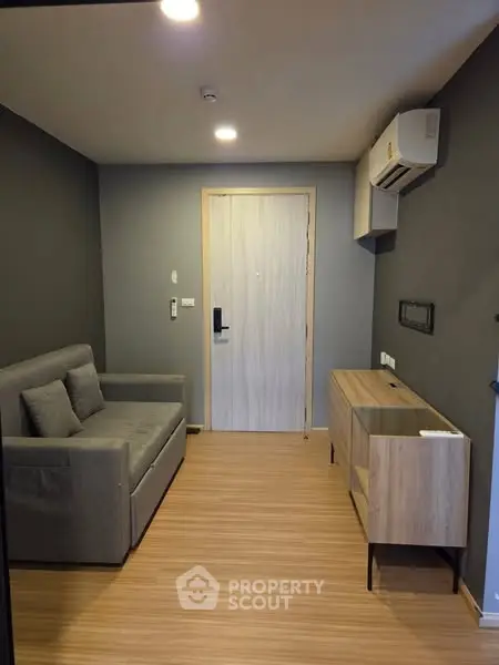Modern living room with sleek furniture and air conditioning in a cozy apartment.