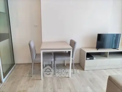 Modern minimalist living room with sleek furniture and light wood flooring.