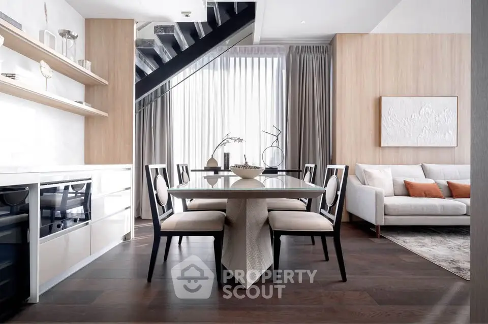 Modern dining and living area with elegant decor and natural light