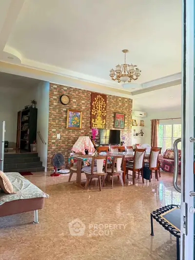 Spacious living room with elegant decor and ample natural light, perfect for family gatherings.