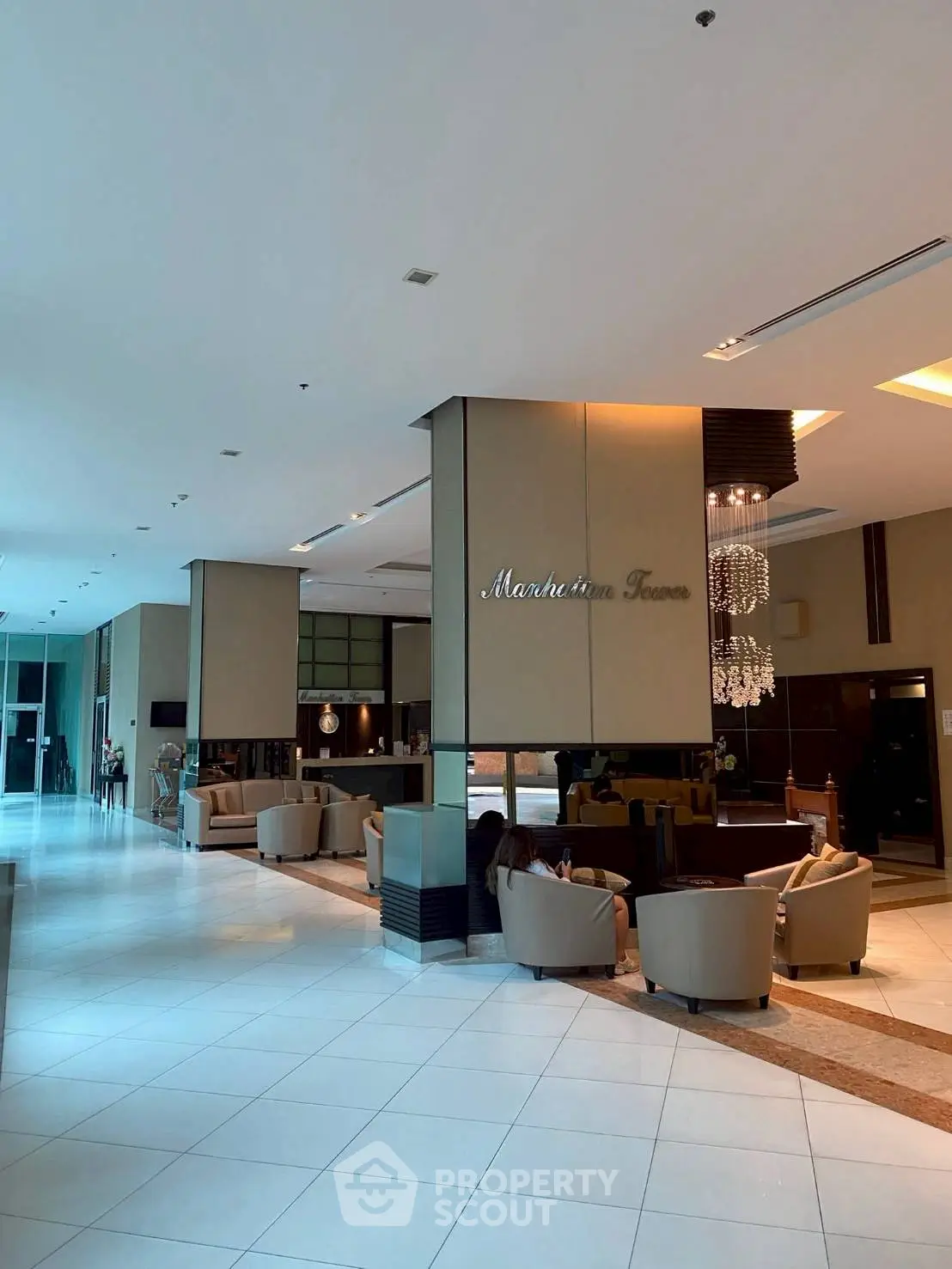 Luxurious lobby with elegant seating and chandelier in upscale building