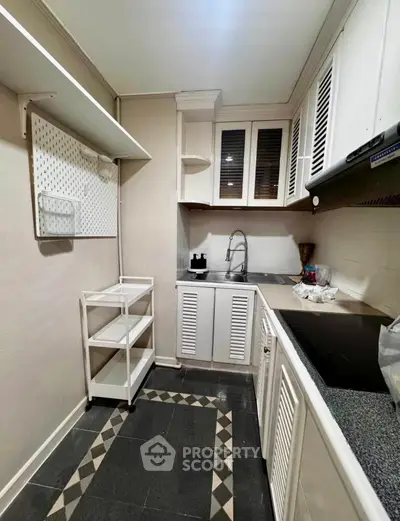 Charming kitchen with closed layout and modern appliances, perfect for culinary enthusiasts.