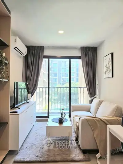 Bright and cozy living room with modern decor and large window view.