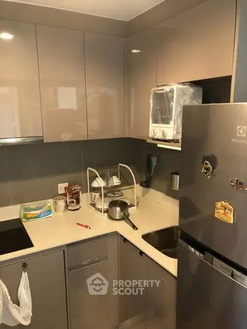Modern kitchen with sleek cabinetry and stainless steel appliances in a compact layout.