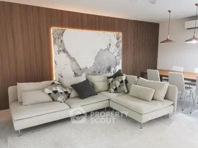 Modern living room with stylish sofa and elegant dining area