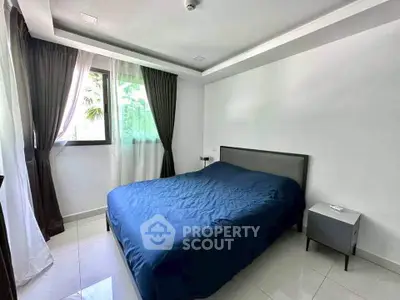 Modern bedroom with large window and stylish decor in a contemporary apartment.