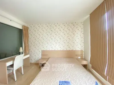 Cozy bedroom with floral wallpaper and modern furnishings in a bright apartment.