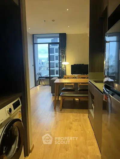 Modern apartment interior with open kitchen and city view balcony.
