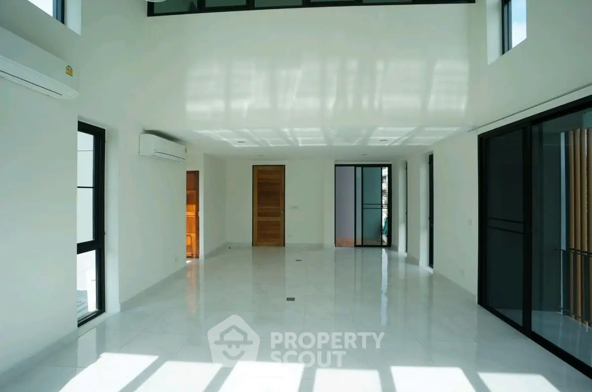 Spacious modern living room with high ceilings and large windows