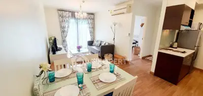 Charming open-plan living and dining area with modern decor and natural light.